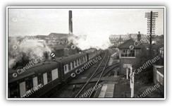 (1950s) South Wales Pullman passes by Ely Station (Chivers Jam Factory in the background)